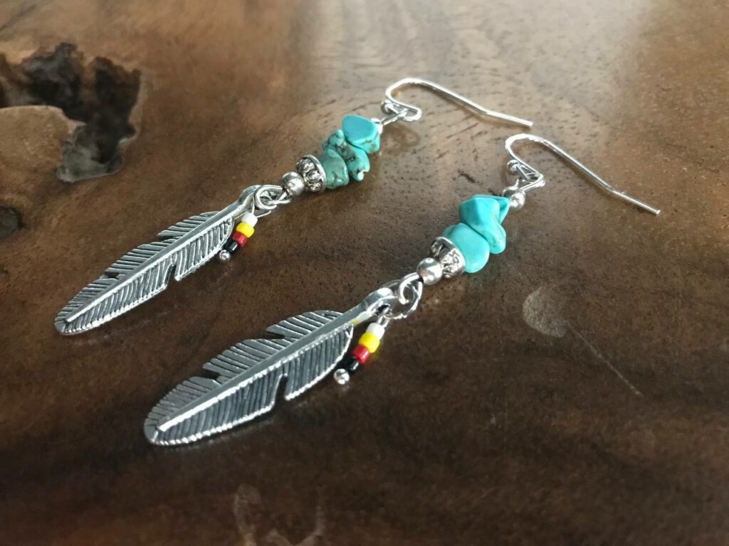 handcrafted earrings, featuring beautiful turquoise beads and a delicate feather charm in an enchanting Native American style