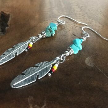 handcrafted earrings, featuring beautiful turquoise beads and a delicate feather charm in an enchanting Native American style