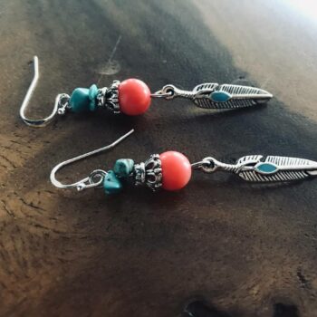 handcrafted earrings, featuring beautiful turquoise beads and a delicate feather charm in an enchanting Native American style